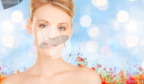 Image of beautiful young woman face over blue background