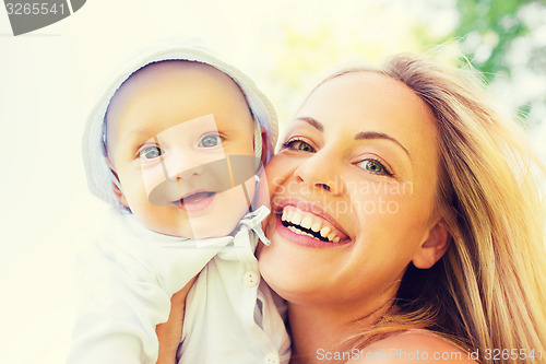 Image of happy mother with little baby outdoors