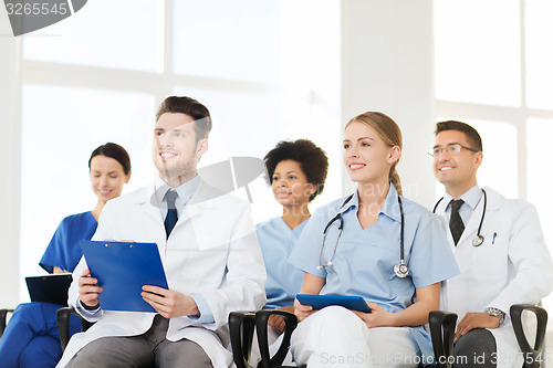 Image of group of happy doctors on seminar at hospital