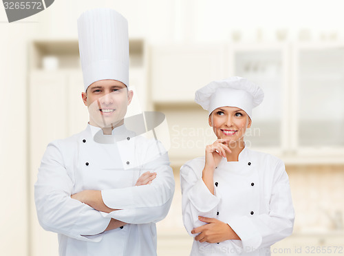 Image of happy male chef cook with crossed hands