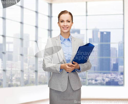 Image of smiling businesswoman holding folder