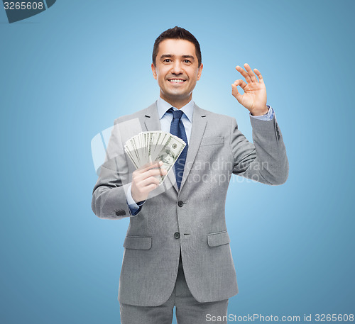 Image of smiling businessman with american dollar money