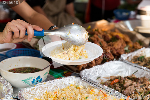 Image of close up of hands with wok at street market