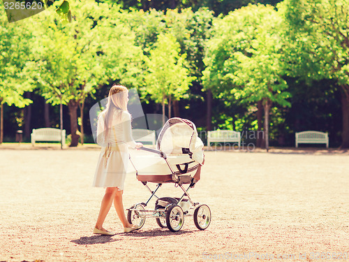 Image of happy mother with stroller in park