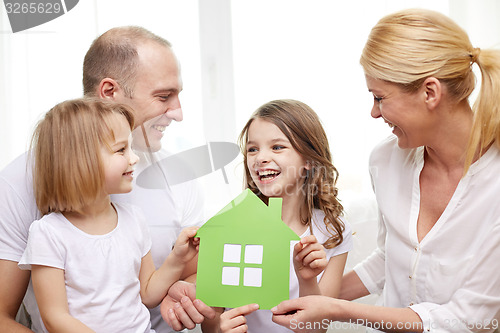 Image of smiling parents and two little girls at new home