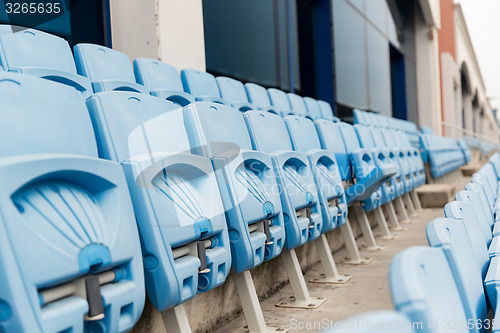 Image of rows with folded seats of bleachers on stadium