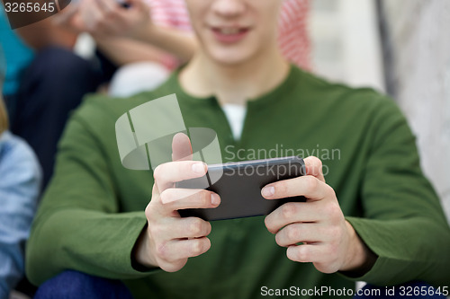 Image of close up of young man with smartphone