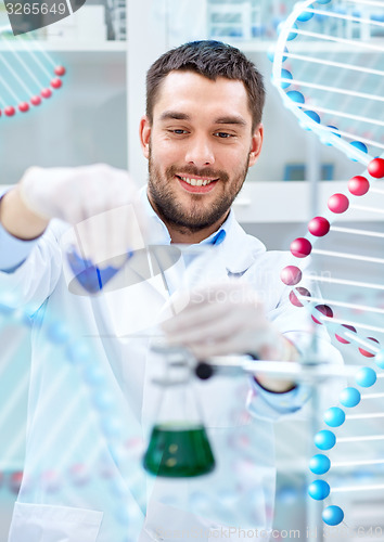 Image of scientist with test tubes making research in lab