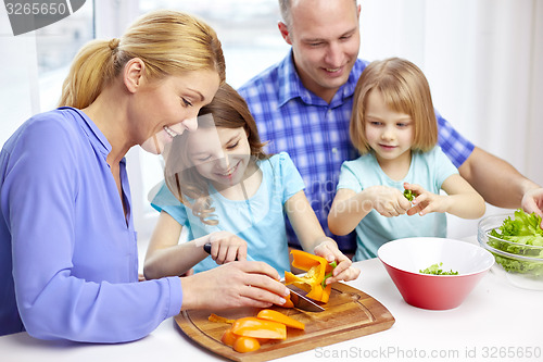 Image of happy family with two kids cooking at home