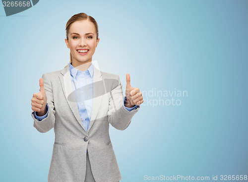 Image of smiling businesswoman showing thumbs up