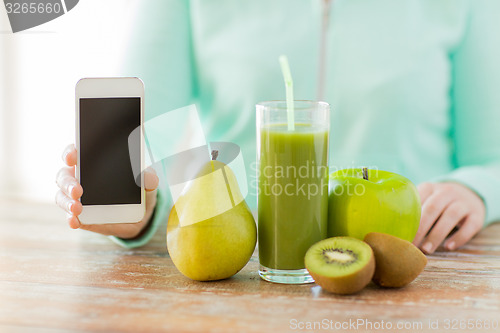 Image of close up of woman hands smartphone and fruit juice