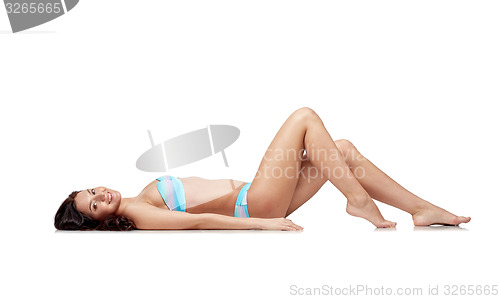 Image of happy young woman lying in bikini swimsuit