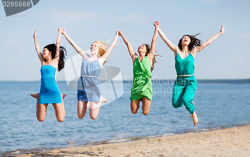 Image of girls jumping on the beach