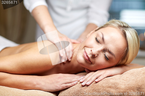 Image of close up of woman lying and having massage in spa