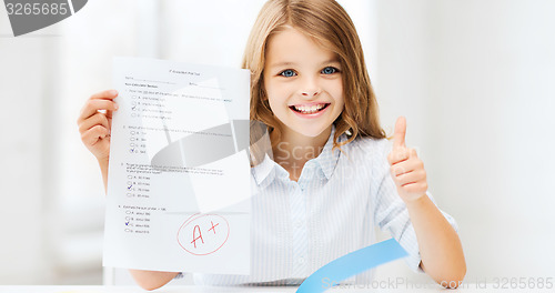 Image of girl with test and grade at school