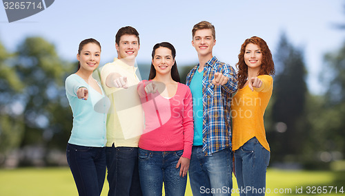 Image of group of smiling teenagers over green park