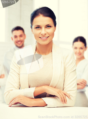 Image of attractive young businesswoman in office