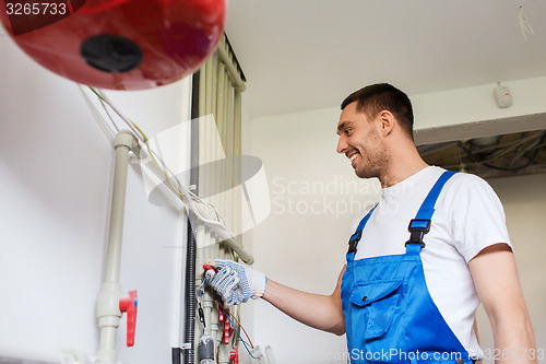 Image of builder or plumber working indoors