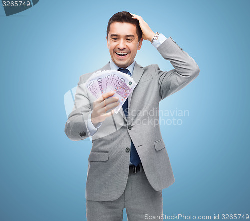 Image of happy laughing businessman with euro money