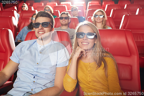 Image of happy friends watching movie in 3d theater