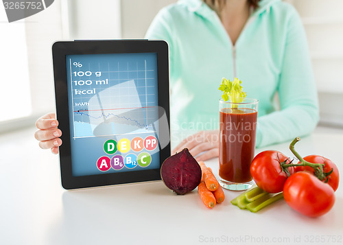 Image of close up of woman with tablet pc and vegetables