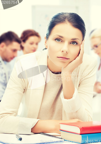 Image of stressed businesswoman in office