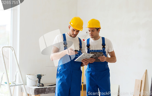 Image of builders with tablet pc and equipment indoors