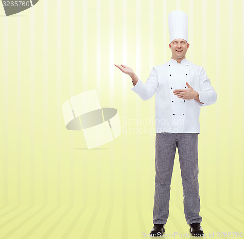 Image of happy male chef cook inviting