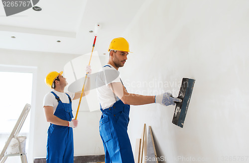 Image of group of builders with tools indoors