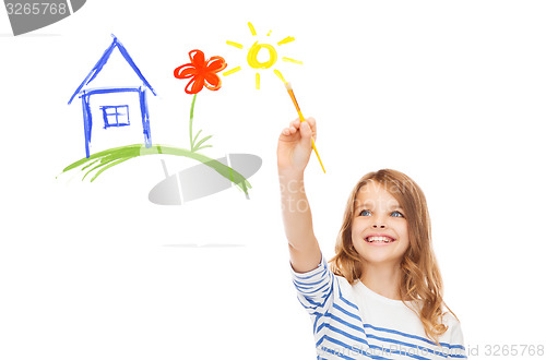 Image of cute little girl drawing house with brush