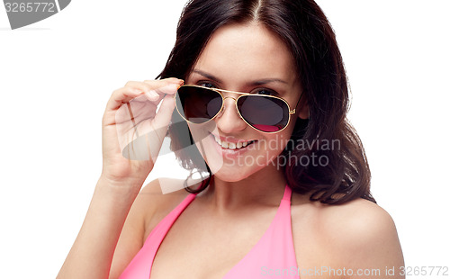 Image of happy woman in sunglasses and swimsuit