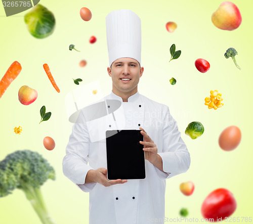 Image of happy male chef cook showing with tablet pc
