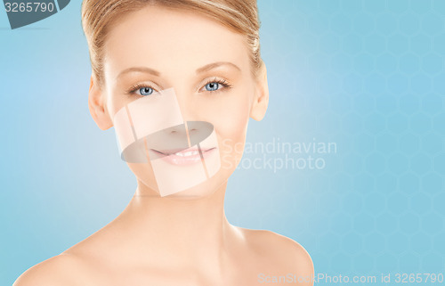 Image of beautiful young woman face over blue background