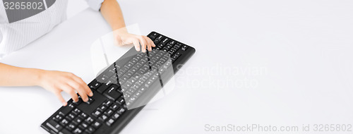 Image of student girls hands typing on keyboard