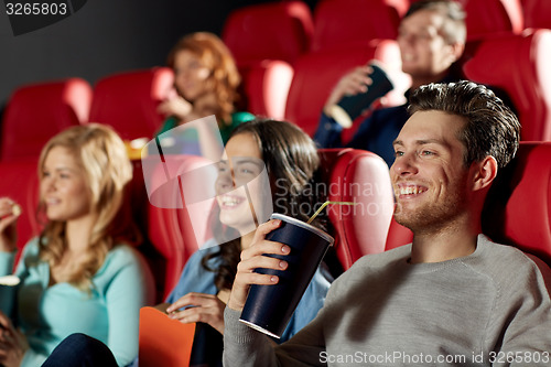 Image of happy friends watching movie in theater