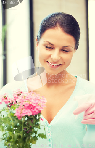 Image of lovely housewife with flower