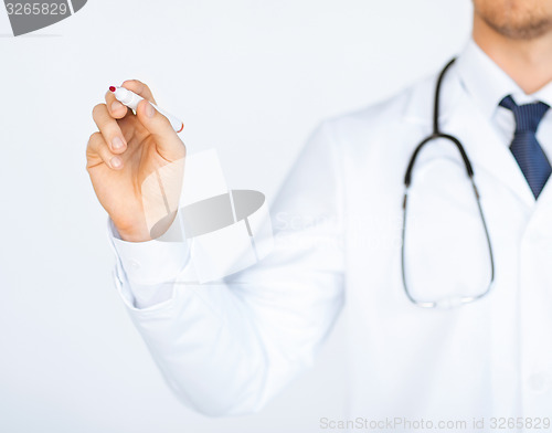 Image of doctor writing something in the air