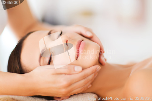 Image of beautiful woman in spa salon having facial