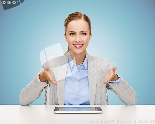 Image of business woman with tablet pc sitting at table