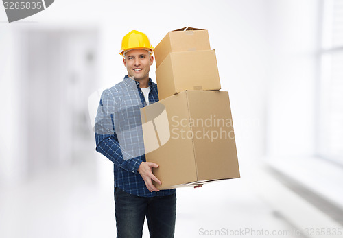 Image of smiling man in helmet with cardboard boxes