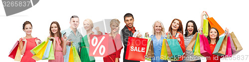 Image of happy people with sale sign on shopping bags