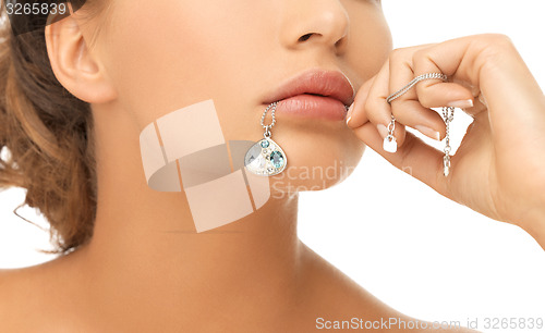 Image of woman diamond pendant in mouth