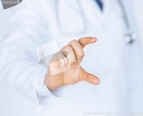 Image of male doctor holding something in his hand