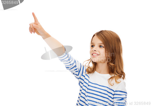 Image of smiling girl pointing at virtual screen