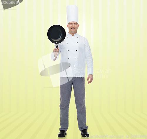 Image of happy male chef cook holding frying pan