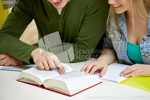 Image of close up of students reading book or textbook