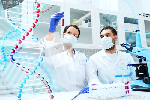 Image of scientists with test tubes making research in lab