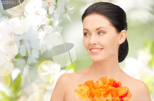 Image of beautiful young woman with flowers