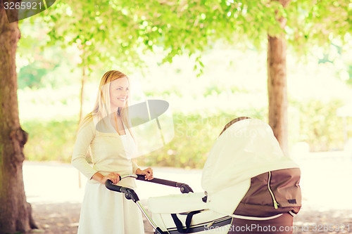 Image of happy mother with stroller in park