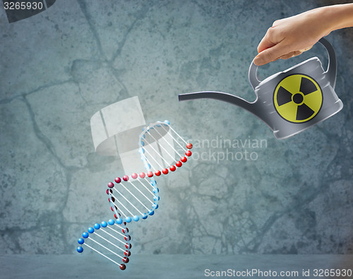 Image of close up of hand with watering can and dna